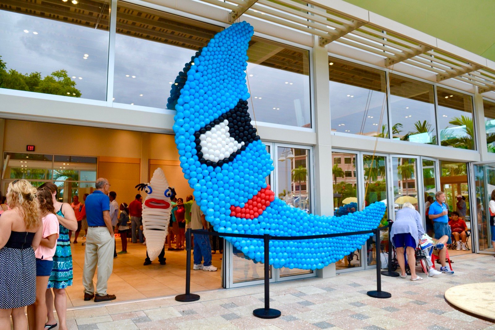 Large blue balloon fish display at an event